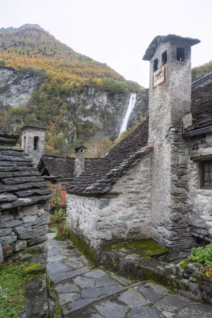 Stone path inside the Village of Foroglio with a view of the Waterfall