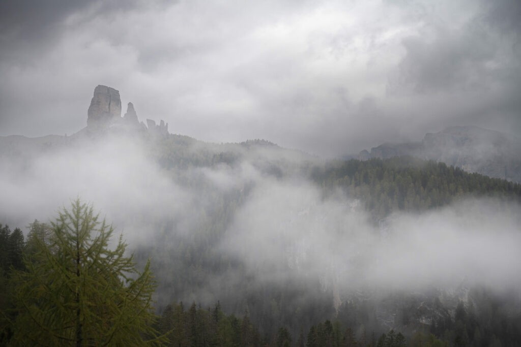 Le Cinque Torri in the dolomites surrounded by clouds, viewed from the hike to Lago di Federa.