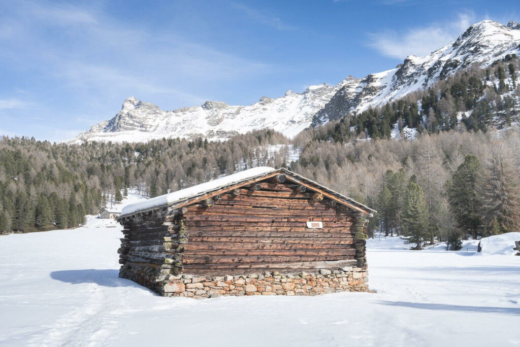 Mountain hut in a snow-covered landscape on a sunny day in the Swiss mountains