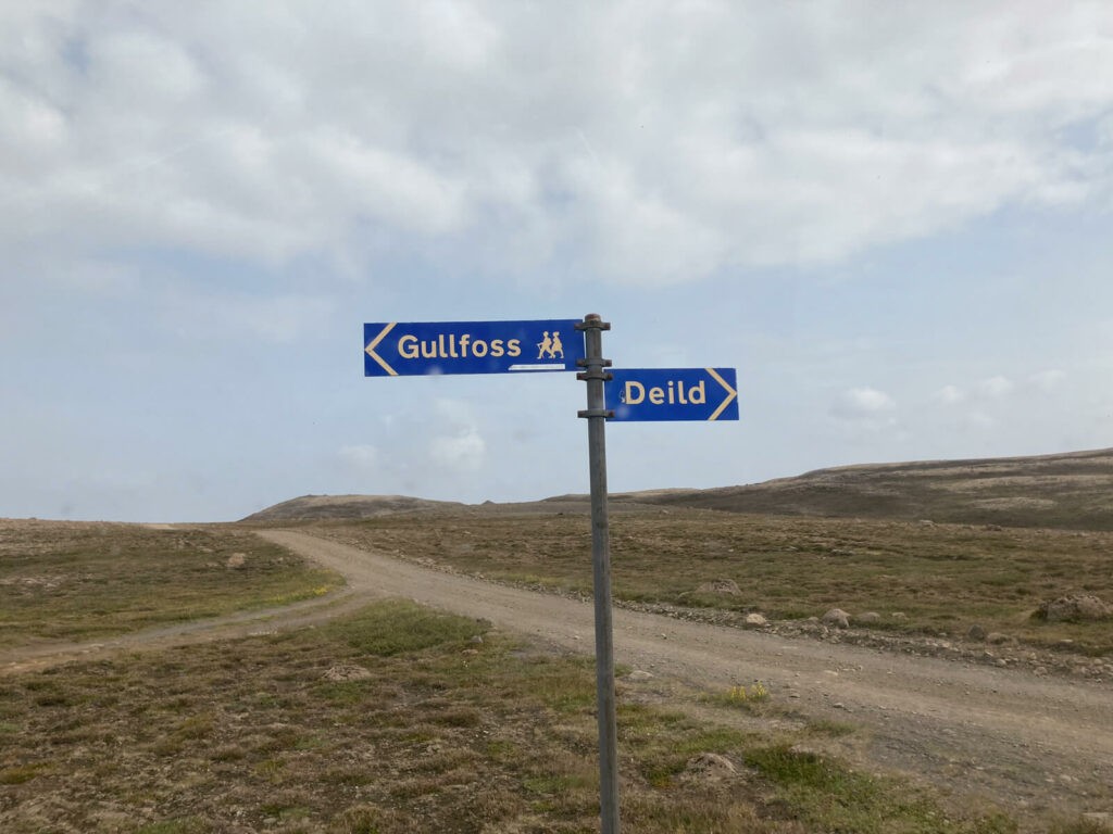 Gullfoss East hiking trail sign on a dirt road in iceland.