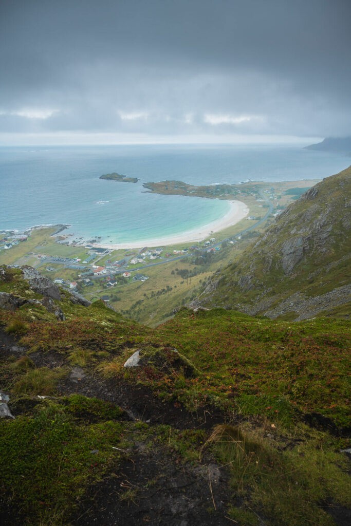 Ramberg beach and the blue waters of the sea viewed from the top of Nubben on a cloudy and Rainy day.
