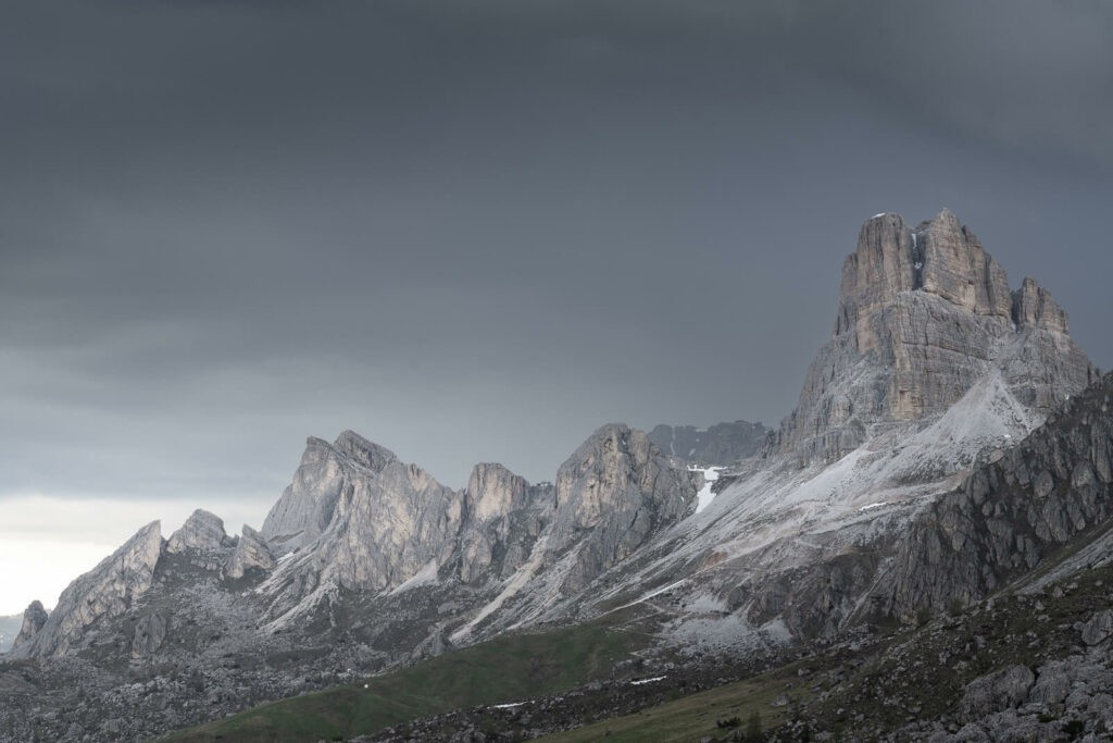 light on the side of the mountains above pass giau in Italy just before the onset of a Summer storm.