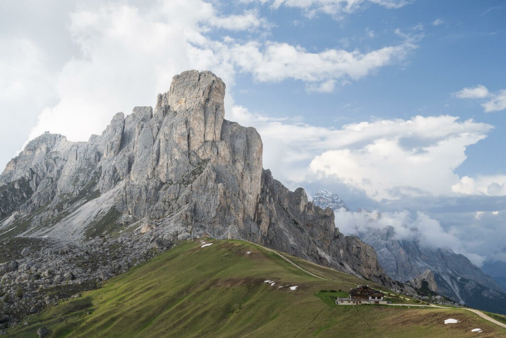 Blue skies and clouds above pass giau and the mountain ra Gisela in the dolomites 