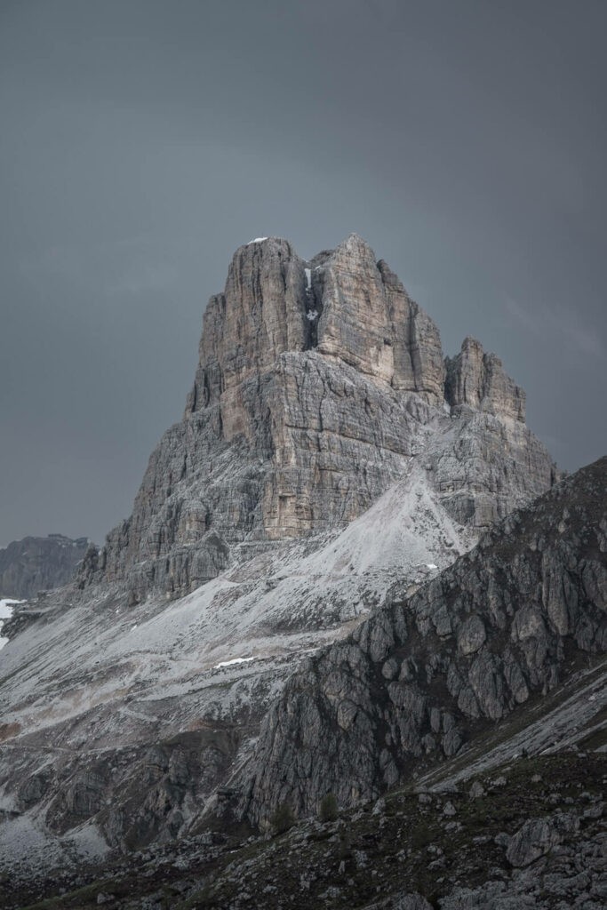 Dark and moody image of a rocky peak in the dolomites