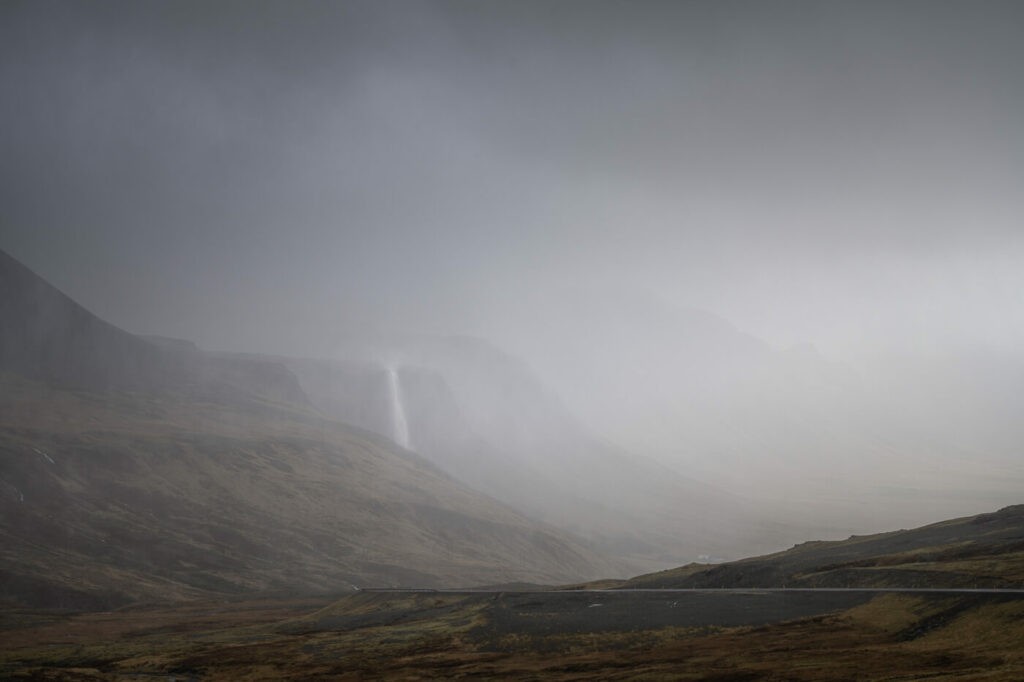 Waterfall in Iceland in the mist during on a cloudy and moody day.