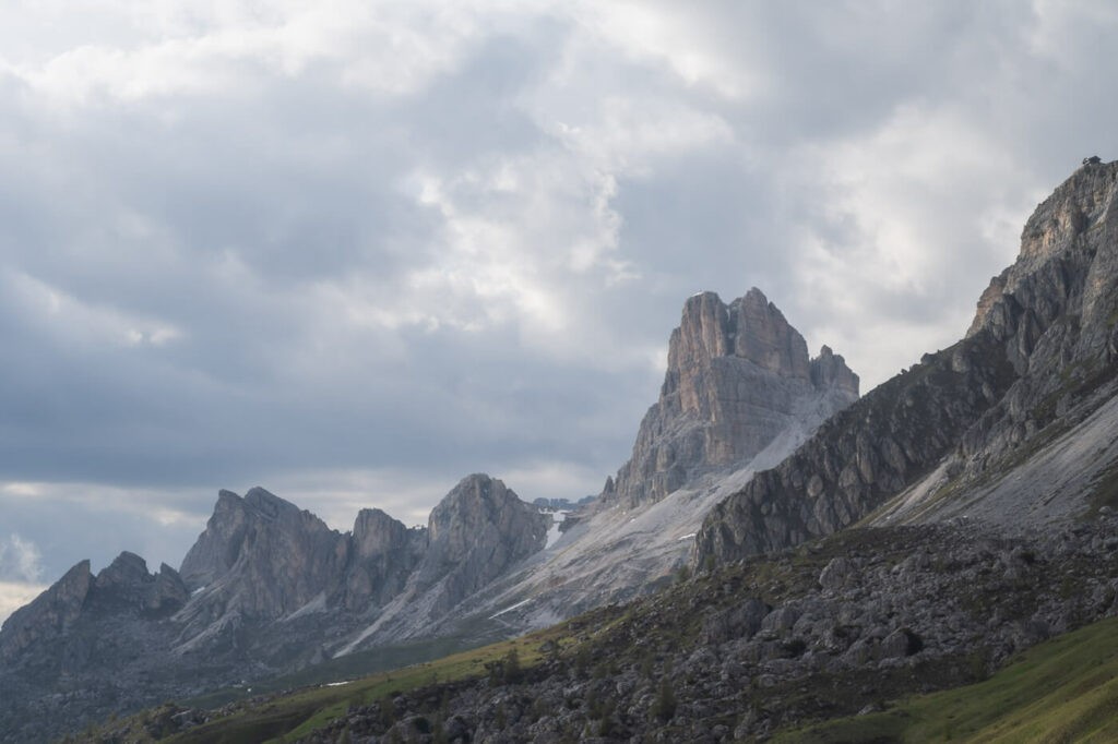 towering peaks of pass Giau in the Dolomites on a cloudy day.