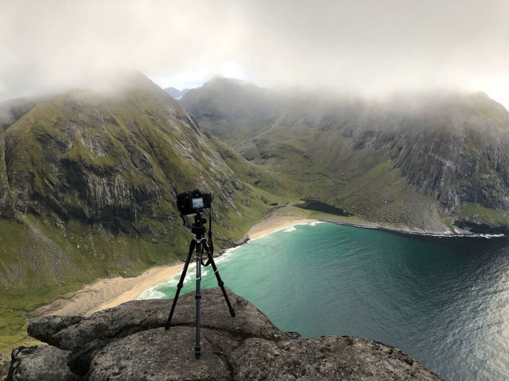 Camera and tripod on top of a mountain in Norway.