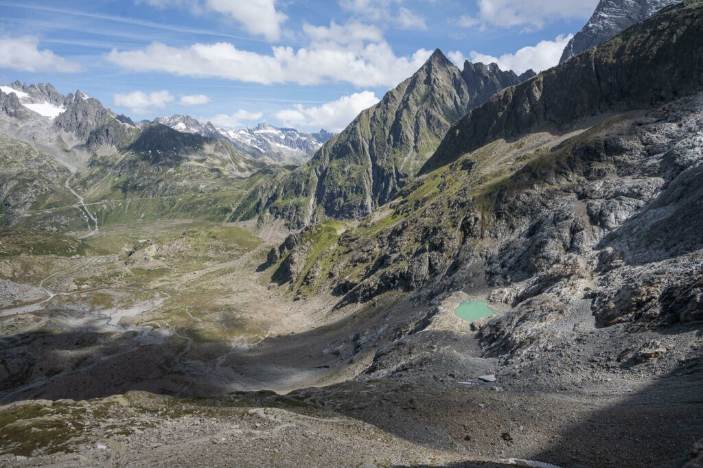 View of the mountain landscape and a small alpine lake around the Sustenpass