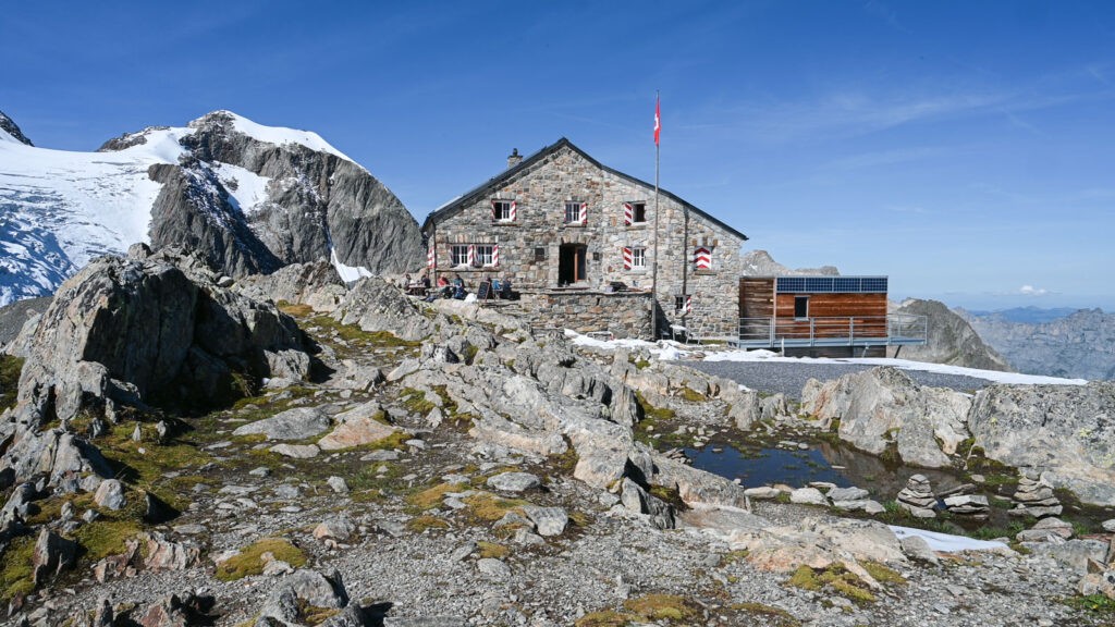 Tierberglyhutte on a sunny day with a glacier in the background