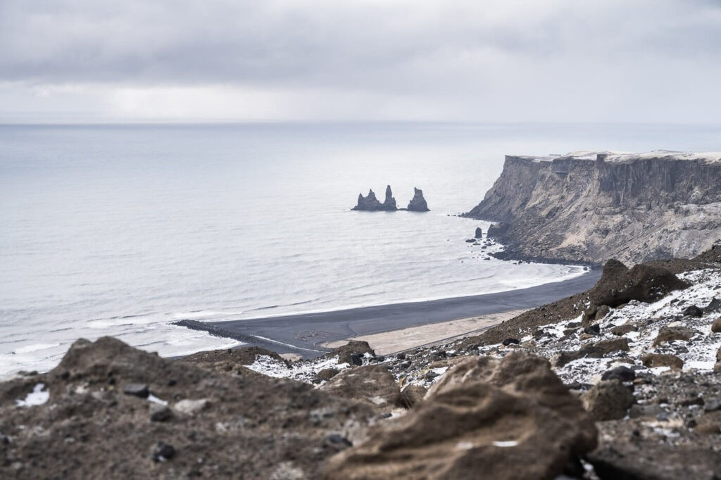 View of the Reynisdrangar sea stacks from the hiking trail to hatta above vik in iceland