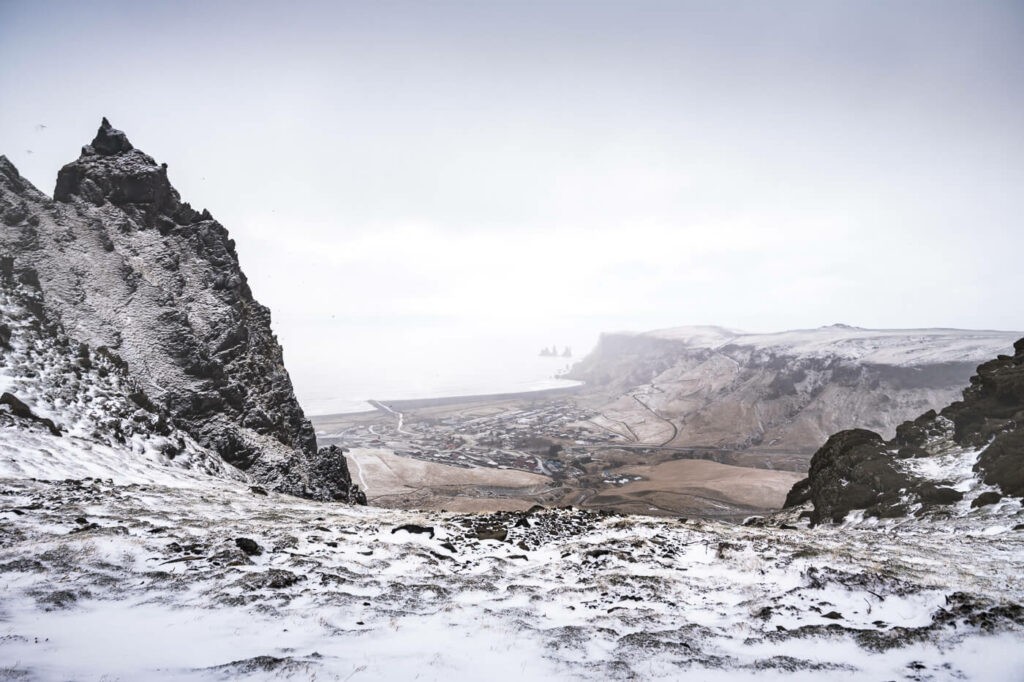 View of a snowy landscape from a cliff on the hike from Vik to Hatta in south Iceland